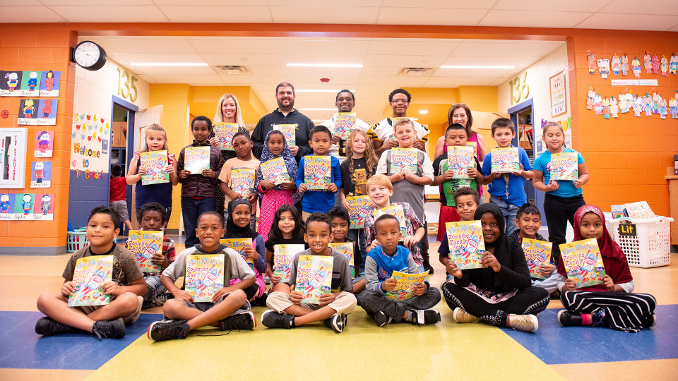 school children and athletes posing with books